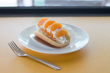 Orange topped on pancakes in coffee shop