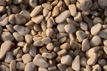 Background of smooth white pebbles. The concept of nature. Cropped shot, close-up, horizontal, top view