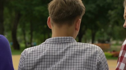 Supportive parents visiting son on campus, family discussing problems together