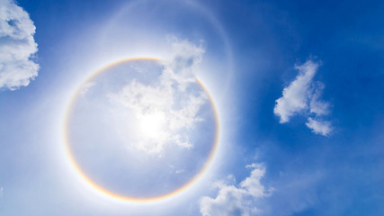 Naklejka na ściany i meble sun corona rainbow clouds and blue sky background , Circumscribed halo
