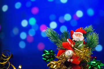 toys, gifts, Christmas decorations on table with reflection on bokeh background with blurred background