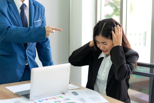 angry boss point fingers blaming  to Asian business woman employee  at office place - Business concept