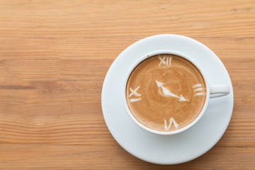 Closeup of A cup of Latte Art hot coffee over wooden  table top background in coffee's shop
