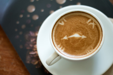 Closeup of A cup of Latte Art hot coffee over wooden  table top background in coffee's shop