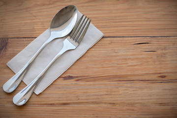 Silverware, fork  spoon and paper put on wooden dining table set in left hand focused for make copy space on right hand image for make food concept background