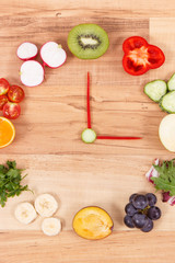 Clock made of fruits and vegetables, time for healthy nutrition concept