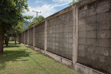 Fototapeta na wymiar Concrete texture wall board fence panels in perspective view with green grass , Original dimension 5472 x 3648 pixels