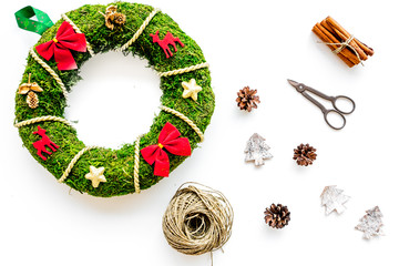 Process of making christmas wreath concept. Green christmas wreath near matherials and instruments, sciccors on white background top view