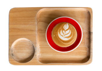 Piccolo Latte art in small glass with red ceramic plate topping beautiful flower art from milk