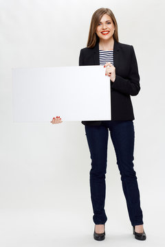 smiling woman in black business suit holding white board