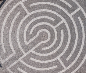 Picture of the maze on the road top view. Decorative labyrinth in the yard.