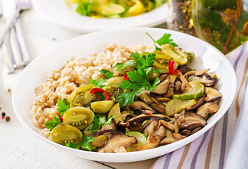 Diet menu. Healthy vegetarian meal - mushrooms shiitake, zucchini  and oatmeal porridge on bowl. Vegan food.