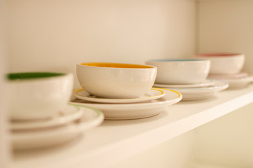 Fototapeta na wymiar colored cups in the cupboard