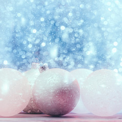 Christmas card with decorative balls over holiday abstract background.