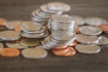Row of coins on wood background for finance and Saving concept,Investment, Economy, Soft focus and dark style.