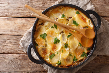 Janssonin Kiusaus four Ingredient Finnish Potato Bake closeup on the table. Horizontal top view