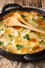 Janssonin Kiusaus four Ingredient Finnish Potato Bake closeup on the table. vertical