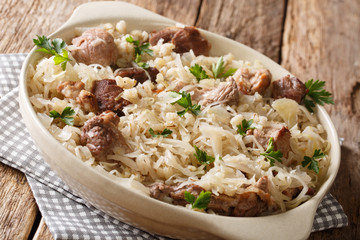Traditional Estonian festive dish of pork, barley and sauerkraut closeup on the table. horizontal