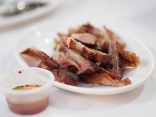Grilled pork on white disk