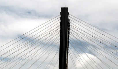 Steel cables of a bridge surrounded by clouds