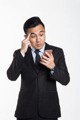 Man with tired and losing expression looking at his phone