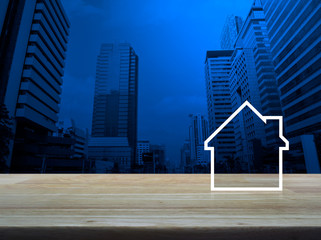 House flat icon with copy space on wooden table over modern office city tower and skyscraper, Business real estate concept