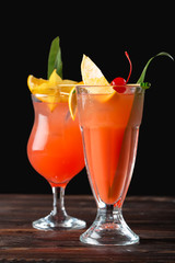 Alcoholic and non alcoholic cocktails on wooden table. Summer cold drinks