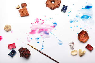 splashes of watercolor paint and painting supplies  close up
