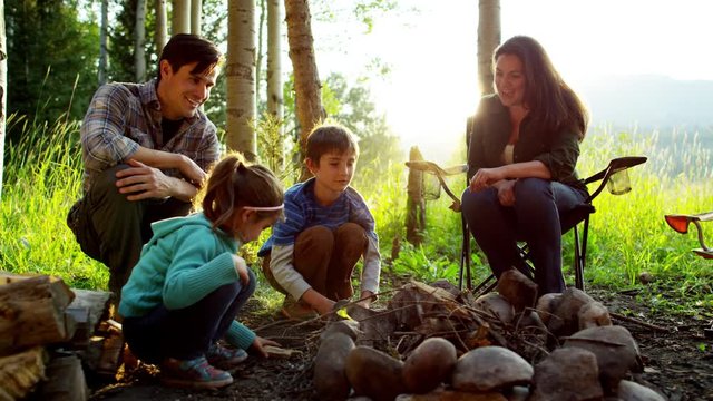 American Caucasian family camping in forest on holiday outdoors