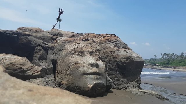 Buddha Head Carved in a Rock on a Bitch in India