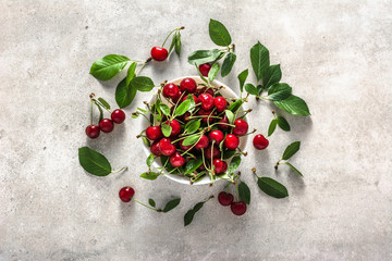 Fresh cherry on plate on white background, ripe cherries, sweet fruit, top view