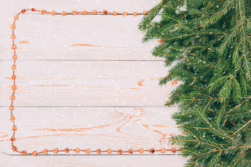 Christmas composition. Christmas pattern with tangerines, fir branch, top view, flat, blue background, retro style, it is snowing. have toning. Copy space.