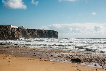 Beautiful view of the Atlantic Ocean and in the distance the fortress of Sagres in Portugal.