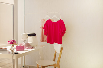 Workplace for sewing and needlework in a bright room with white furniture.