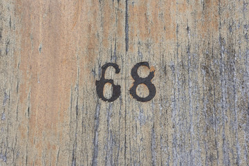 Number 68 on a wood texture background