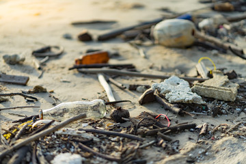 branch tree plastic foam glass bottle rubbish dump on sand sea beach from deep sea after finish strong wind rain monsoon