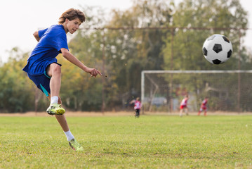Obraz premium Young children player on the football match