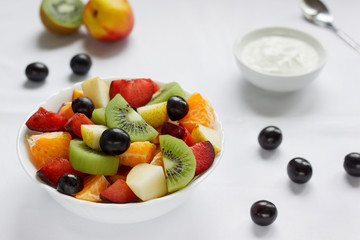 Fresh salad of various fruits with yogurt. Healthy lifestyle.