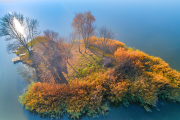 Aerial view of a small island on a lake in autumn