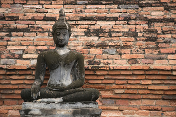 Fototapeta premium Buddha Statue at Wat Mahathat in Sukhothai Historical Park, Unesco world heritage. of Thailand .