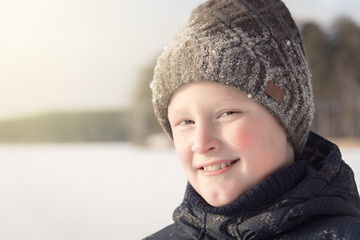 Smiling teenage boy in winter