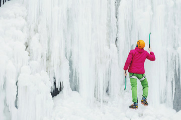 Ice climbing on a frozen waterfall.