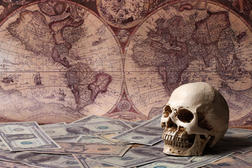 Capitalism Concept : Skull on Banknote with Vintage Map Background