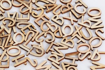 a heap of wooden letters are lying in the white studio