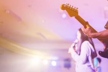 soft focus hands man playing guitar on stage in worship night concept.