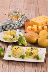 Potato gratins with broccoli florets. 