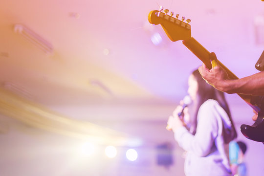 soft focus hands man playing guitar on stage in worship night concept.