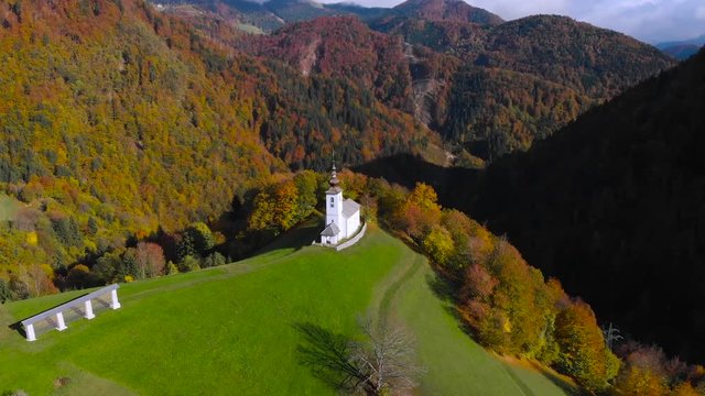 Lonely church on hilltop in picturesque rural Slovenia, 4K aerial drone footage.