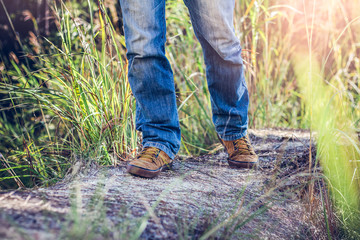 Close up shoes of hiker man on mountain trail