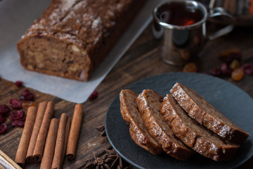 Homemade banana bread with anis star and cinnamon on a dark wooden background